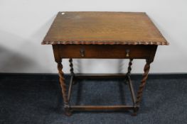 A 20th century oak pie crust edge barley twist side table fitted with a drawer