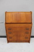 A mid century teak bureau