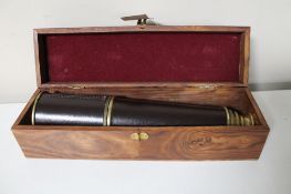 A brass and leather cased nautical telescope in fitted box