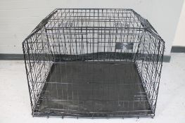 A folding metal dog cage