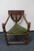 A carved triangular armchair