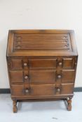 An oak linen fold writing bureau