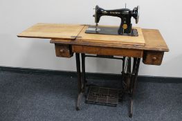 A Singer treadle sewing machine in oak table