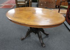 A Victorian inlaid oval breakfast table on carved four way support