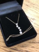 A 10ct yellow gold diamond set pendant on chain