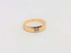 A 9ct gold band ring set with a small diamond, size T. CONDITION REPORT: 2.4g.
