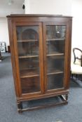 An Edwardian oak double door glazed bookcase