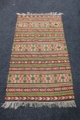 A fringed eastern kilim rug