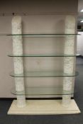 A Barker and Stonehouse Corinthian style four tier glass shelf stand, width 140 cm,
