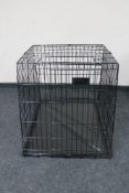 A folding metal dog cage width 67 cm