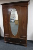 An Edwardian mahogany mirror door wardrobe