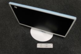 A Samsung model T24D391 EW HD TV monitor with lead and remote