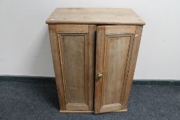 An antique pine double door cabinet