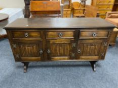 A Siesta Chapmans oak triple door sideboard fitted with three drawers