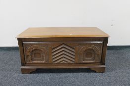 A carved oak blanket box