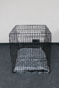 A folding metal dog cage width 67 cm