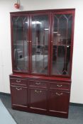 A mahogany effect triple door display cabinet