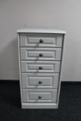 A white narrow five drawer chest