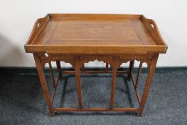 A folding Eastern table with brass inlaid and lift off gallery tray