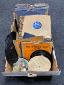 A box of vinyl records and a record player stylus