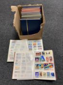 A box of thirteen stamp albums of world stamps relating to space travel, fish,