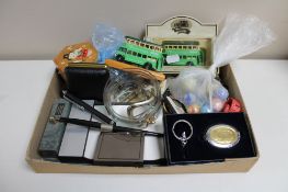 A box of pens, golfing belts, die cast vehicles, travel clock, padlocks,