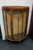 A 1930's walnut D-shaped display cabinet