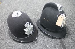 Two policeman's helmets - West Midlands and Northumbria