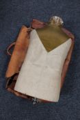 A vintage mannequin torso together with a leather valise