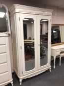 A Laura Ashley cream double mirror door wardrobe,