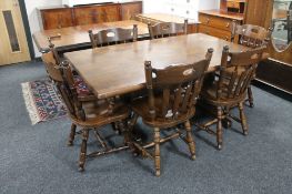 An oak checker board top refectory dining table and six chairs