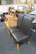 A pair of brown leather high backed dining chairs together with a contemporary coffee table and