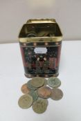 A metal tin of pre decimal British coins and foreign coins