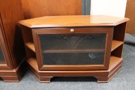 A contemporary corner TV stand with matching audio cabinet