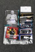 A quantity of James Bond collectables to include four Corgi die-cast vehicles, books, mug, magazine,