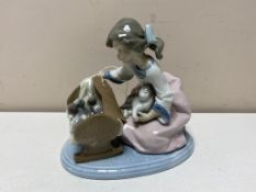 A Lladro figure - girl with cat and kittens
