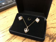 A 10ct gold aquamarine pendant and matching earrings
