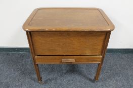 A mid 20th century oak sewing trolley