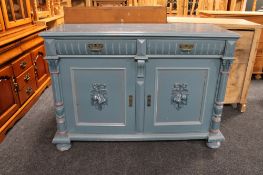 An antique painted double door sideboard on bun feet