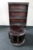 A set of mahogany open shelves and a revolving media stand