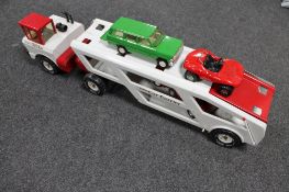 A Mighty car carrier and four cars including a VW Beetle