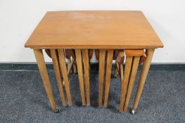 A nest of five mid 20th century teak tables