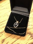 A 10ct gold diamond set pendant on chain