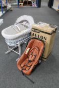 A Moses basket on stand and a boxed Aulon child's car seat