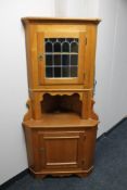 An oak corner display cabinet