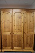 A pine triple door wardrobe