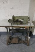 An industrial Necchi sewing machine in Singer table