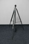 A contemporary metal tripod standard lamp base