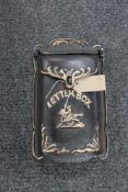 A cast iron wall mounted letter box