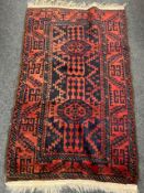 A fringed Persian rug of geometric design